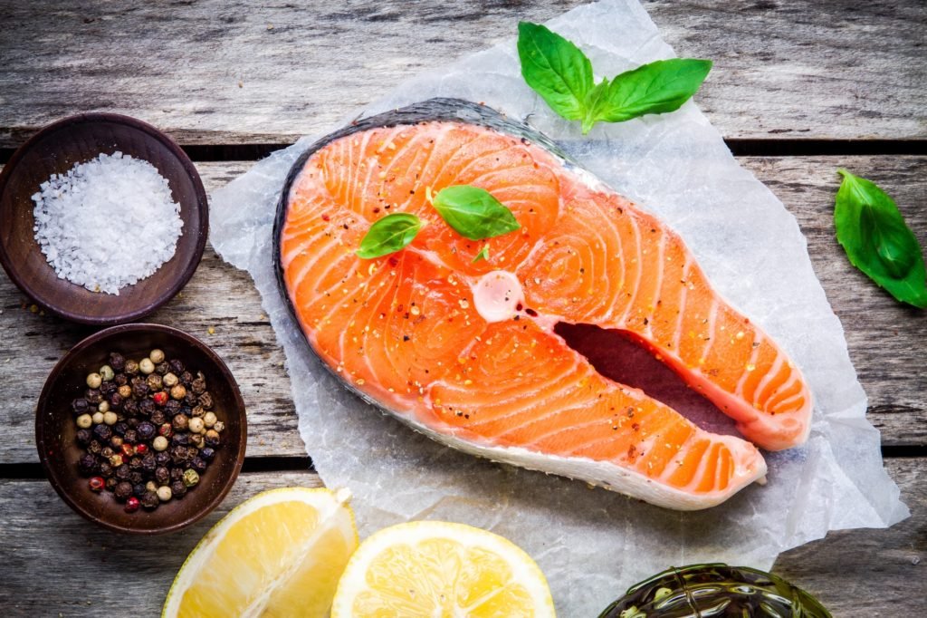 Fresh Raw Salmon Steak With Salt, Lemon, And Basil